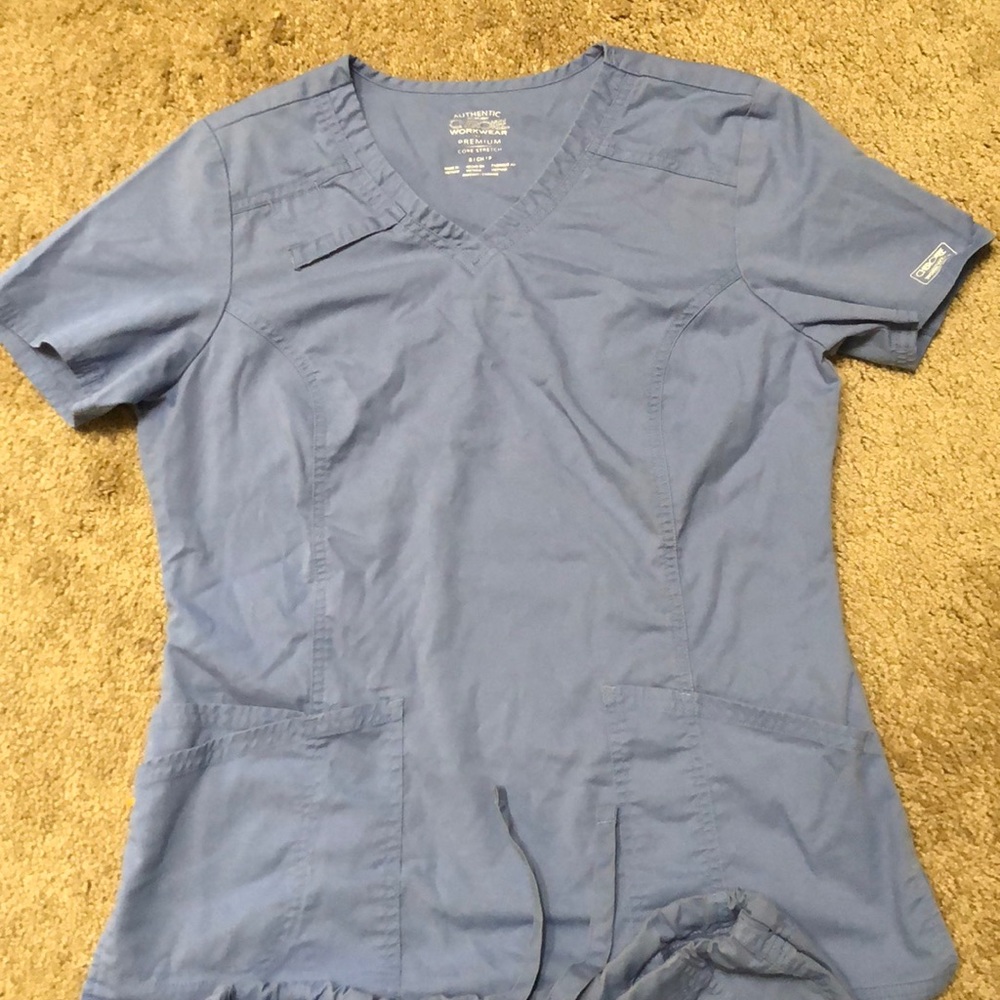 2 sets of light blue scrubs.